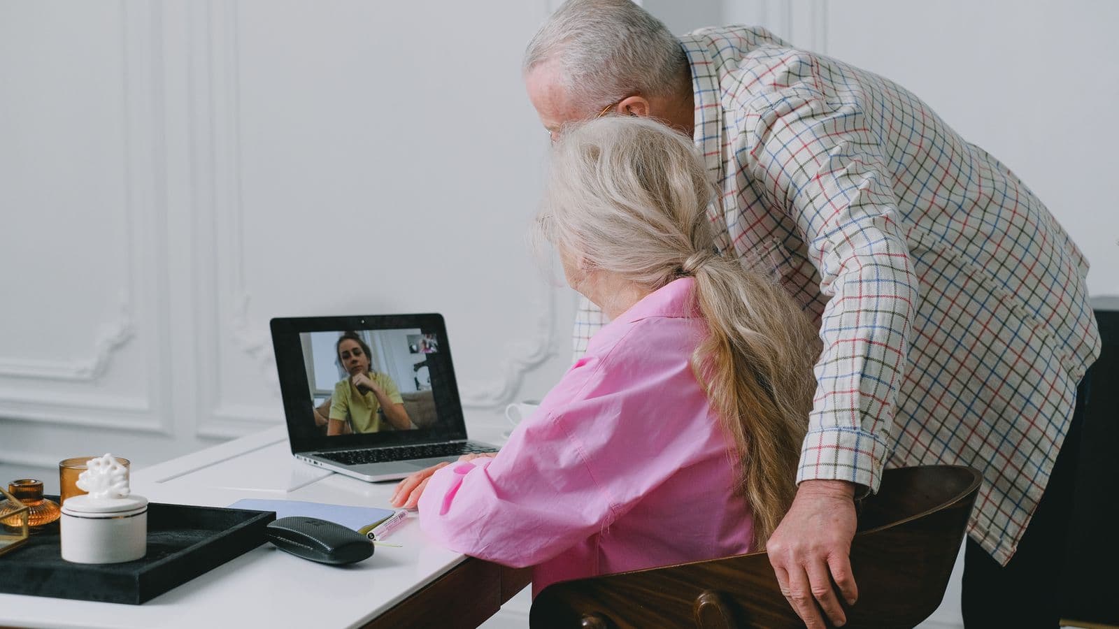 A woman on a video call with family members in another country