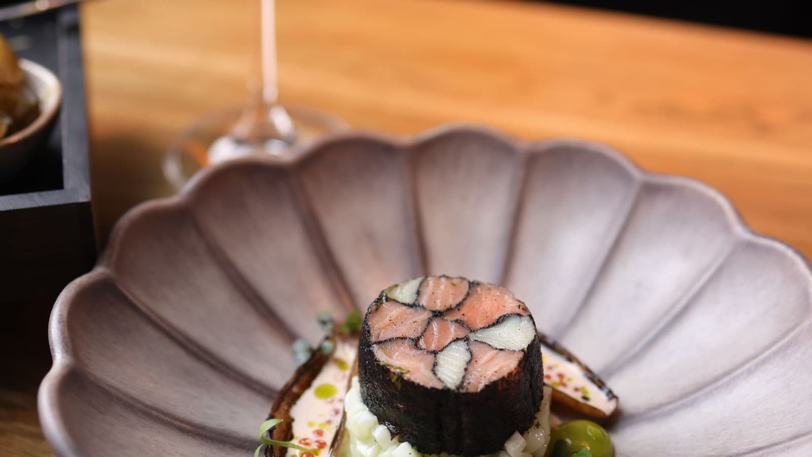 Tasting menu course being served at a fine dining restaurant