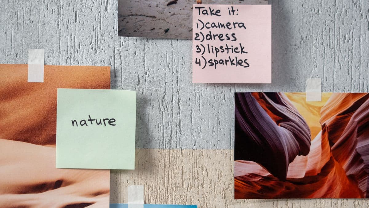 Travel photos and handwritten notes pinned to a wall