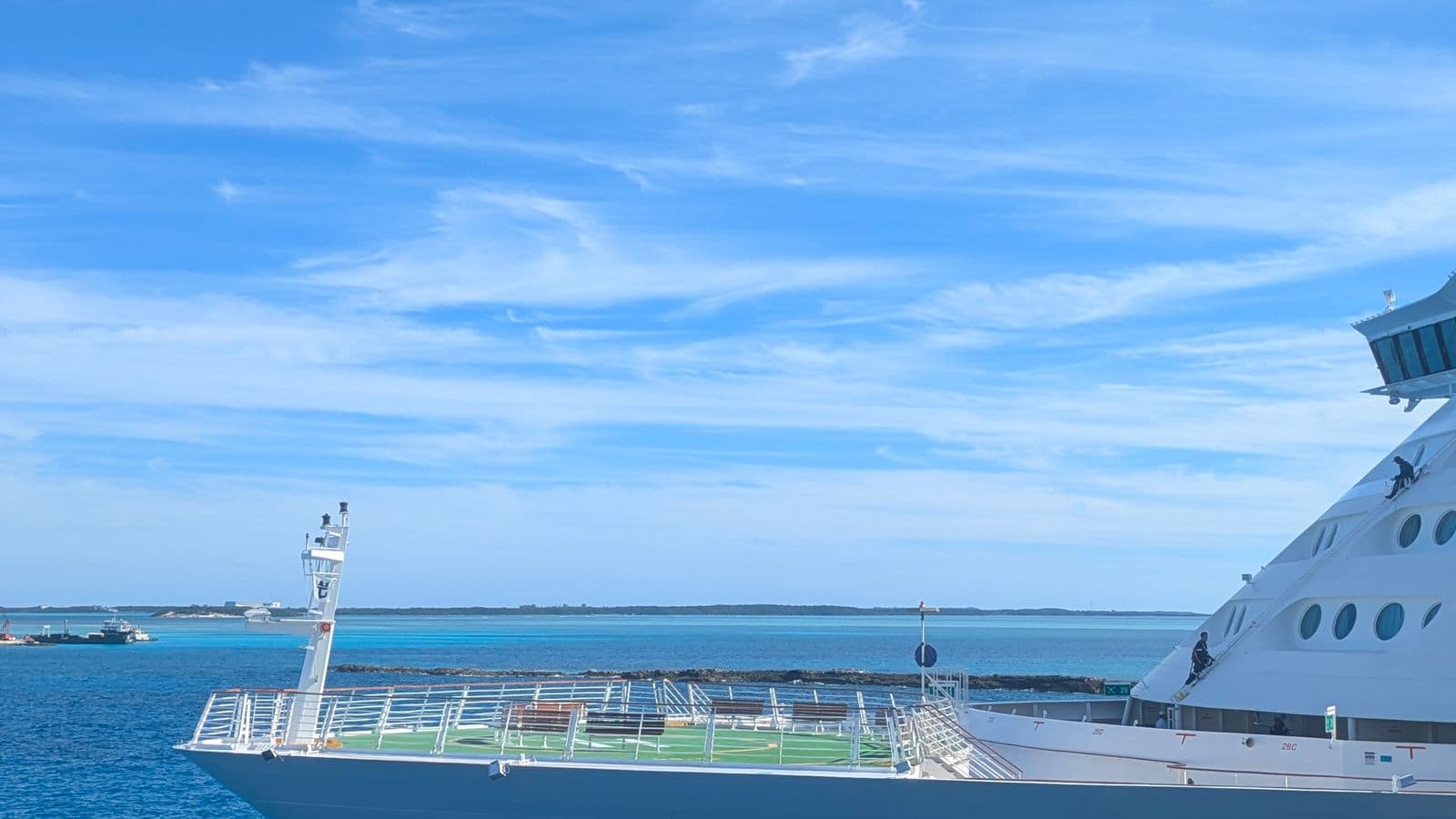 Cruise ship sailing the open ocean under a clear blue sky