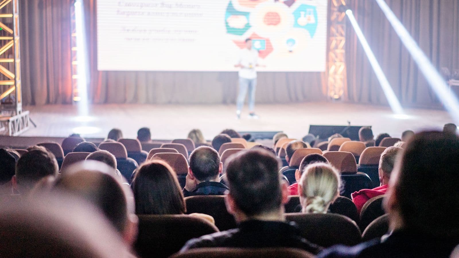 Audience watching a keynote presentation at a conference