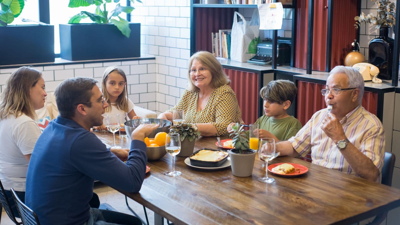 Grandparents and family members talking together at a table