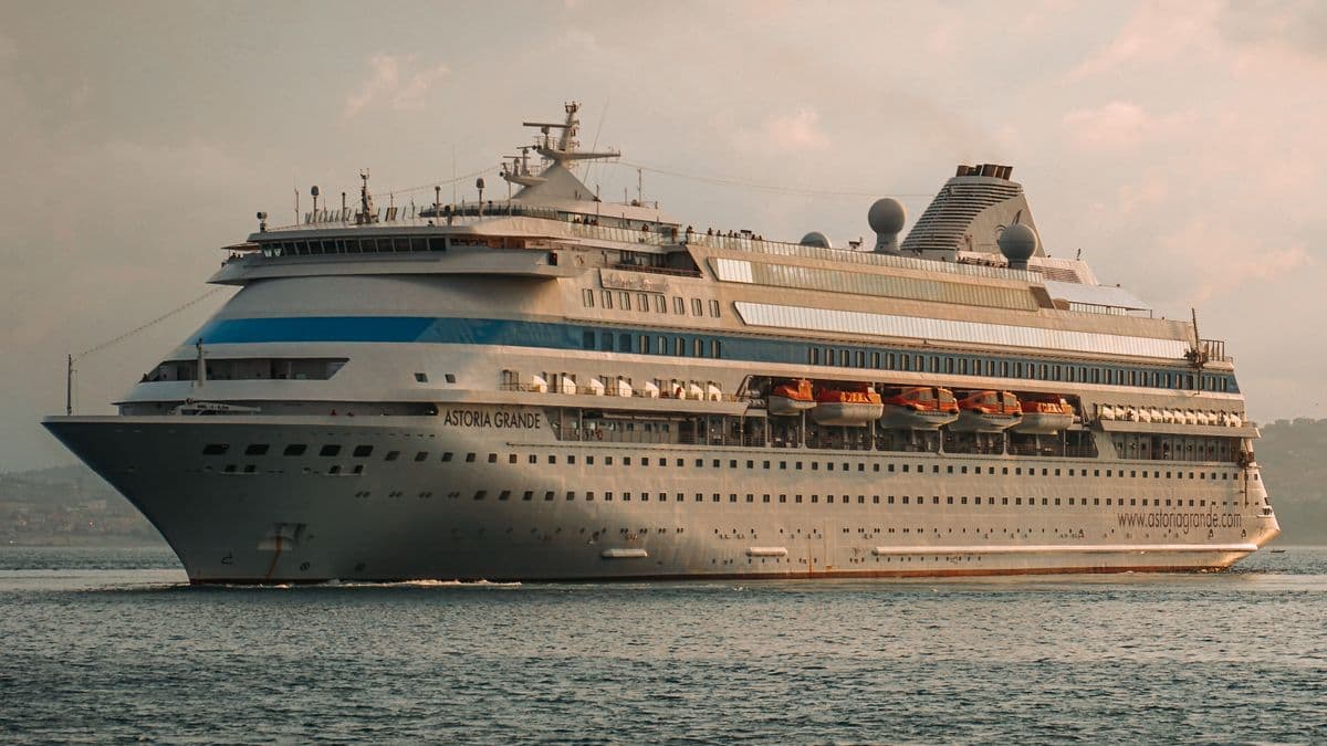 Cruise ship sailing at sunset