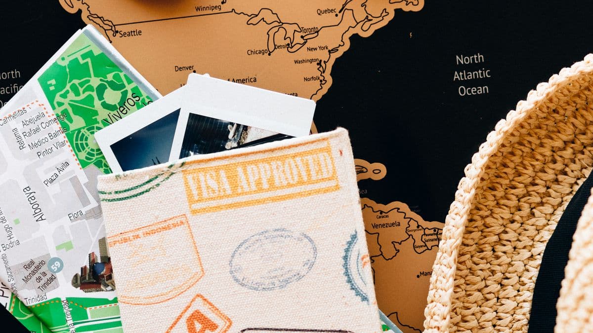 Passport wallet, maps, and travel keepsakes laid out on a world map